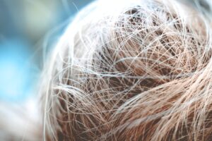 a close up of a person's hair with a blurry background