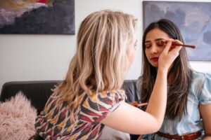 Makeup artist applies makeup to a clients eyes