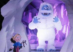 a man dressed as a monster and a woman dressed as a snow monster