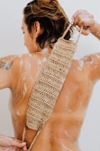 Woman Washing Her Back with Scrubber