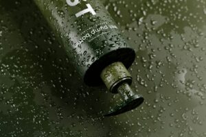 a close up of a water bottle on a wet surface