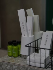 Boxes of Toiletries and Lotion Bottles in Hotel Bathroom | Travel-Size Skincare