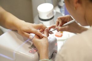 a woman getting her nails done at a nail salon | Nail Prep