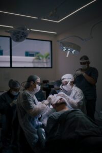 Surgeons conduct a hair transplant procedure in a modern operating room.