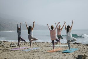 five woman standing on seashore | Achieving Wellness Goals