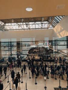 A large group of people walking around a building | TSA-Approved Toiletry Bags