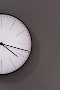 white analog wall clock at 11 00