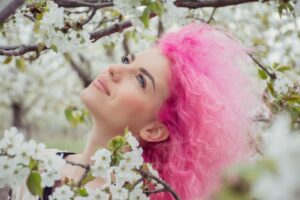 woman covered by white flowers | The Art of Hair Color