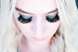 woman showing black eyelashes | Lash Extensions