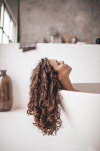 woman in bathtub | Add volume to your hair