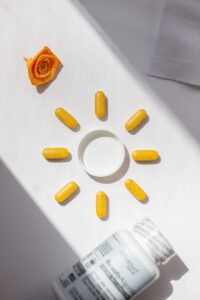 A bottle of pills and a rose on a table