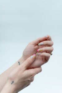 a woman with a tattoo on her left hand | Nail Foils