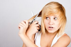 A woman holding a pair of scissors in her hands