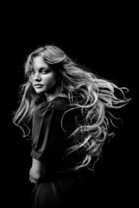 a black and white photo of a woman with long hair | Long Layered Haircut