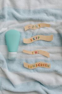 Promote skin health with a reminder to apply sunscreen daily from a flat lay photo.
