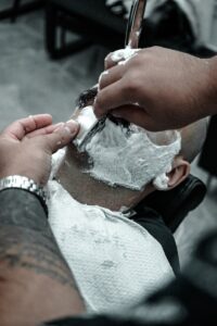 A man getting his hair cut by a barber
