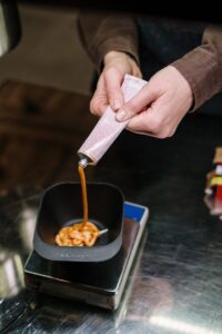Image of hair dye being squeezed into a bowl, showcasing salon preparation process.
