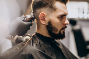 Barber demonstrating classic cutting techniques and beard grooming]