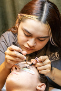 Cameo College student learning lash brow enhancement techniques