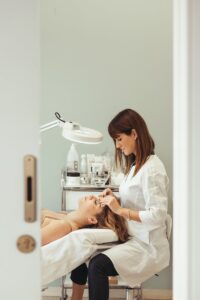 Beautician performs facial treatment in salon, enhancing skincare and relaxation.