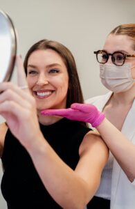 A beautician assists a woman with skincare in a modern beauty salon, enhancing her natural look.