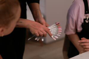 a woman holding a bunch of nails in her hands