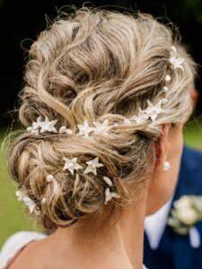 Elegant updo with star and pearl hair accessories